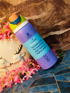 Purple insulated water bottle with text on a decorative surface with flowers and a deer figurine.