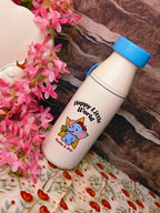 White water bottle with blue lid featuring a cartoon elephant and text, surrounded by pink flowers on a floral fabric background.