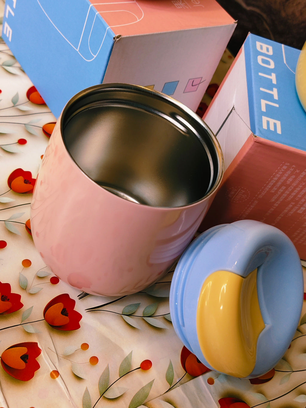 Pink and bluetumbler with a floral background