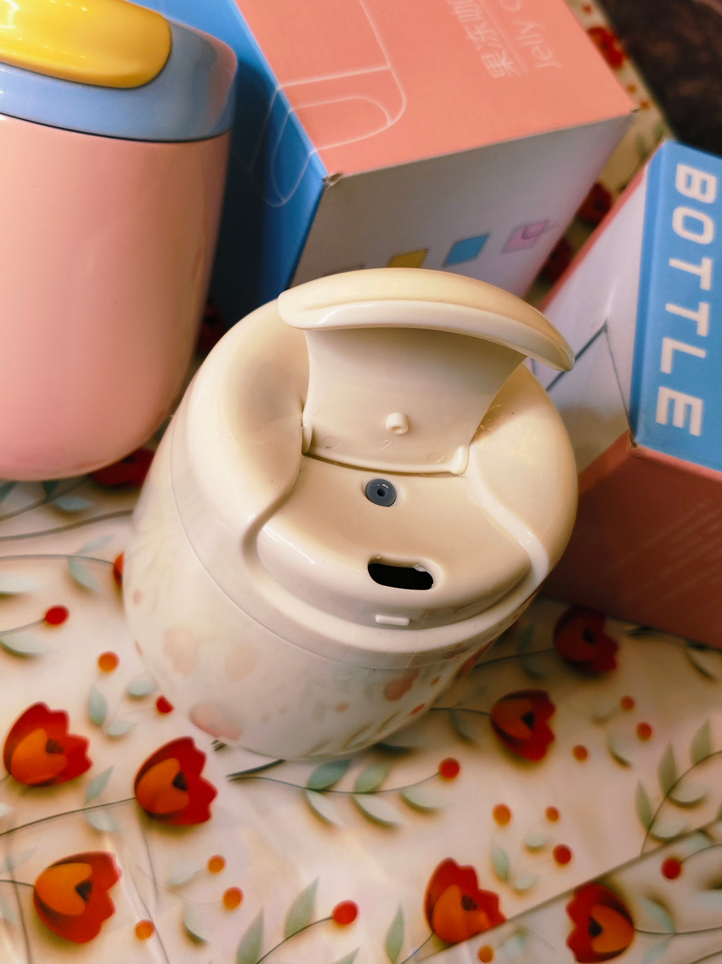 Close-up of a white tumbler with a lid on a floral surface
