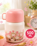 Pink meal stainless steel food  jar with floral design and a matching cup filled with soup, on a checkered tablecloth.